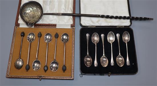 Two cased sets of six silver spoons and a white metal toddy ladle.